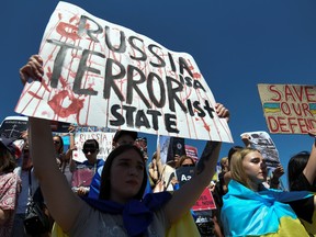 Relatives and friends of defenders of the Azovstal Iron and Steel Works in Mariupol hold a rally demanding to recognize Russia as a state sponsor of terrorism after killing Ukrainian prisoners of war in a prison in Olenivka, outside of Donetsk, as Russia's attack on Ukraine continues, in Dnipro, Ukraine, Sunday, Aug. 7, 2022.