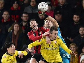 Arsenal's Argentinian goalkeeper Emiliano Martinez punches the ball clear during the English FA Cup fourth round football match  between Bournemouth and Arsenal at the Vitality Stadium in Bournemouth, southern England on January 27, 2020. -