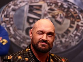 In this file photo taken on April 20, 2022 World Boxing Council (WBC) heavyweight title holder Britain's Tyson Fury winks during a pre-match press conference at Wembley Stadium in west London.
