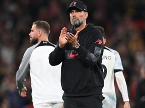 Liverpool's German manager Jurgen Klopp applauds supporters on the pitch after the English Premier League football match between Manchester United and Liverpool at Old Trafford in Manchester, north west England, on August 22, 2022.