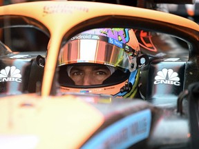 In this file photograph taken on July 8, 2022, McLaren's Australian driver Daniel Ricciardo sits in his car in the pits prior to the first practice session at the Red Bull Ring race track in Spielberg, ahead of the Formula One Austrian Grand Prix.
