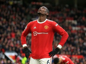 In this file photograph taken on February 26, 2022, then Manchester United's French midfielder Paul Pogba reacts during the English Premier League football match between Manchester United and Watford at Old Trafford in Manchester, north west England.