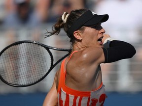 Germany's Andrea Petkovic hits a return to Switzerland's Belinda Bencic during their 2022 US Open Tennis tournament women's singles first round match at the USTA Billie Jean King National Tennis Center in New York, on August 30, 2022.