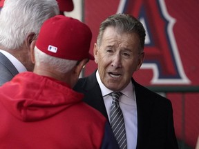 Los Angeles Angels owner Arte Moreno, right, talks with Angels manager Joe Maddon prior to a baseball game against the Cleveland Guardians on Tuesday, April 26, 2022, in Anaheim, Calif.