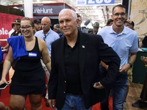 Former Vice President Mike Pence walks through the Varied Industries Building during a visit to the Iowa State Fair, Friday, Aug. 19, 2022, in Des Moines, Iowa.