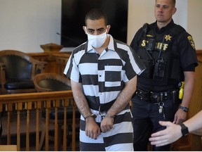 Hadi Matar, 24, centre, arrives for an arraignment in the Chautauqua County Courthouse in Mayville, N.Y., Saturday, Aug. 13, 2022.