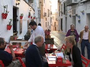 A cobbled street in Arcos de la Frontera serves as an alfresco dining spot.
