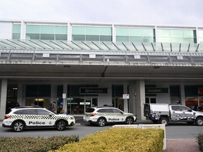 Australian Federal Police attend the Canberra Airport in Canberra, Sunday, Aug. 14, 2022, after a shooting incident.