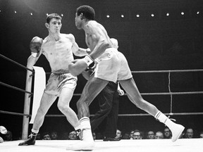 Cuban-born Spaniard Jose Legra, right, attempts to land a left hook to the head of French-born Australian boxer Johnny Famechon during their World Featherweight Title fight, at the Royal Albert Hall, London, on Jan. 21, 1969.