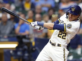Aug 17, 2022; Milwaukee, Wisconsin, USA;  Milwaukee Brewers left fielder Christian Yelich (22) hits an RBI single during the eighth inning against the Los Angeles Dodgers at American Family Field.