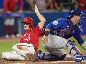 Aug 29, 2022; Toronto, Ontario, CAN; Toronto Blue Jays third baseman Matt Chapman (26) scores the game winning run against the Chicago Cubs on a single by Toronto Blue Jays catcher Danny Jansen (not pictured)during the eleventh inning at Rogers Centre.