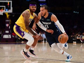 Mar 1, 2022; Los Angeles, California, USA; Dallas Mavericks guard Jalen Brunson moves to the basket against Los Angeles Lakers forward Kent Bazemore during the first half at Crypto.com Arena.