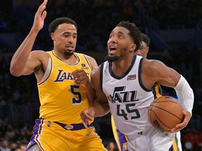 Los Angeles Lakers guard Talen Horton-Tucker defends Utah Jazz guard Donovan Mitchell in the second half at Crypto.com Arena.