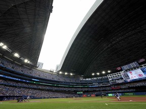 The roof opens at Rogers Centre following a storm that passed over the city, during fourth inning MLB interleague baseball action between the Toronto Blue Jays and the Cincinnati Reds in Saturday, May 21, 2022.