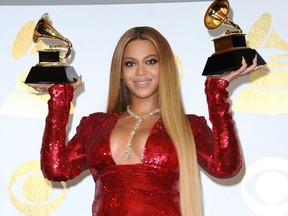 Beyonce holds up her Grammy Awards in 2017.