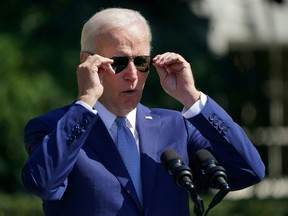 U.S. President Joe Biden adjusts his sunglasses as he speaks during a signing ceremony for the CHIPS and Science Act of 2022, at an event on the South Lawn of the White House in Washington, D.C., on Aug. 9, 2022.