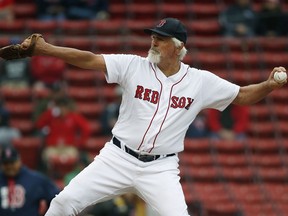 FILE - Former Boston Red Sox's Bill Lee pitches during a Red Sox alumni baseball game on May 27, 2018, in Boston. Lee had stopped breathing after collapsing in the bullpen during an exhibition game on Friday, Aug 19, 2022, but paramedics and two shocks with a defibrillator helped resuscitate the 75-year-old pitcher, according to a witness at the scene.