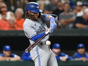 Toronto Blue Jays shortstop Bo Bichette hits a three-run home run against the Baltimore Orioles at Oriole Park at Camden Yards.