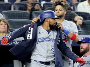 Toronto Blue Jays left fielder Lourdes Gurriel Jr. (13) puts the home run jacket on Teoscar Hernandez (37) after Hernandez's home run against the New York Yankees at Yankee Stadium.