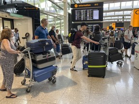 Travellers are seen at Heathrow airport, in London, July 13, 2022.