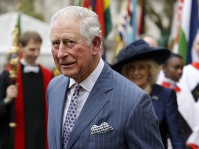 In this Monday, March 9, 2020, photo, Britain's Prince Charles and Camilla the Duchess of Cornwall, in the background, leave after attending the annual Commonwealth Day service at Westminster Abbey in London.