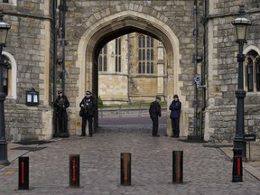 Police guard the Henry VIII gate to Windsor Castle in Windsor, England, Wednesday, Feb. 16, 2022.