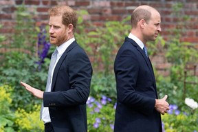Prince Harry, Duke of Sussex (left) and Britain’s Prince William, Duke of Cambridge, attend the unveiling of a statue of their mother, Princess Diana at The Sunken Garden in Kensington Palace, London, on July 21, 2021. DOMINIC LIPINSKI/POOL/AFP VIA GETTY IMAGES