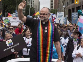 Reverend Brent Hawkes, the pastor who performed Canada's first legally recognized same-sex marriages, rides in a car during Toronto's Pride Parade, June 28, 2015.