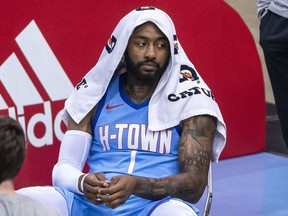 Then-Houston Rockets' John Wall sits on the sideline during a timeout against the Denver Nuggets in an NBA basketball game Friday, April 16, 2021, in Houston.