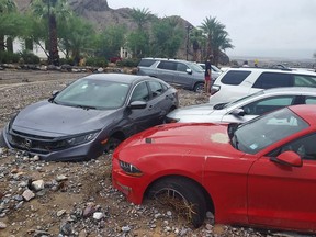 In this photo provided by the National Park Service, cars are stuck in mud and debris from flash flooding at The Inn at Death Valley in Death Valley National Park, Calif., Friday, Aug. 5, 2022. Heavy rainfall triggered flash flooding that closed several roads in Death Valley National Park on Friday near the California-Nevada line. The National Weather Service reported that all park roads had been closed after 1 to 2 inches of rain fell in a short amount of time. (National Park Service via AP)