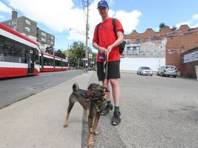 Callum Denault, a university student, stands with Louie, his 18-month-old dog.