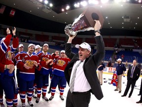 Edmonton Oil Kings Head Coach Derek Laxdal holds up the Western Hockey League's Ed Chynoweth Cup after beating the Portland Winterhawks on Monday May 12, 2014 to win the the WHL championship.