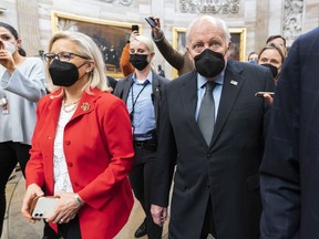 Former Vice President Dick Cheney walks with his daughter Rep. Liz Cheney, R-Wyo., vice chair of the House panel investigating the Jan. 6 U.S. Capitol insurrection, in the Capitol Rotunda at the Capitol in Washington, Jan. 6, 2022.