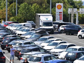 Motorists are parked at a gas station in Berchem in Luxembourg on August 6, 2022 in Berchem.