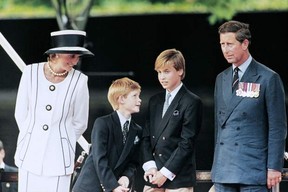 In this file photo taken on Aug. 19, 1995 Prince Charles (right), Princess Diana (left) and their children William and Harry watch the march past on a dais on the mall as part of the commemorations of VJ Day. JOHNNY EGGITT/AFP VIA GETTY IMAGES
