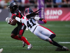 Montreal Alouettes defensive back Kerfalla Exumé (41) tries to stop Ottawa Redblacks wide receiver Terry Williams (81)during first half CFL action in Ottawa on Thursday, July 21, 2022.