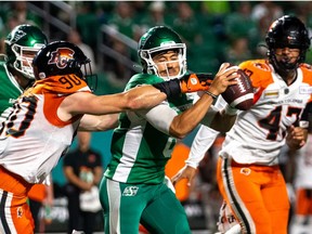 BC Lions defensive lineman Mathieu Betts (90) tackles Saskatchewan Roughriders quarterback Mason Fine (8) during the fourth quarter of CFL football action in Regina, on Friday, July 29, 2022.