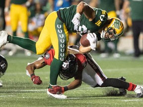 Aug 19, 2022; Ottawa, Ontario, CAN; Edmonton Elks running back Ante Milanovic-litre (34) is tackled by Ottawa REDBLACKS defensive back Randall Evans (2) in the second half at the TD Place stadium.