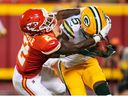 Green Bay Packers safety Dallin Leavitt is tackled by Kansas City Chiefs cornerback Dicaprio Bootle 
 during the second half at GEHA Field at Arrowhead Stadium. 