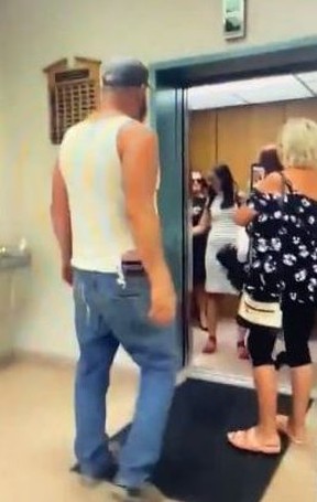 An unidentified man in a white tank top was captured on video shouting obscenities at Deputy Prime Minister Chrystia Freeland as she entered an elevator at City Hall in Grande Prairie, Alta., before he was escorted out of the building.