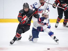 Jocelyne Larocque of Canada battles Amanda Kessel and Hannah Bilka of USA during The IIHF World Championship Woman's ice hockey match between Canada and USA in Herning, Denmark, Tuesday, Aug 30, 2022.
