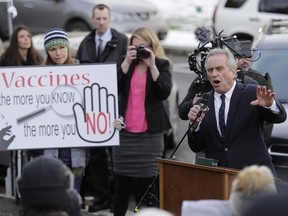 Robert Kennedy Jr., right, speaks at a rally held in opposition to a proposed bill that would remove parents' ability to claim a philosophical exemption to opt their school-age children out of the combined measles, mumps and rubella vaccine, Friday, Feb. 8, 2019, at the Capitol in Olympia, Wash.