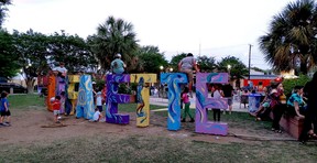 Kids play on the Lafayette sign during the Festival International de Louisiane in Lafayette, La. (Dave Pollard/Toronto Sun)