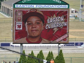 A picture of Mountain Region Champion Little League team member Easton Oliverson, from Santa Clara, Utah, is shown on the scoreboard at Volunteer Stadium during the opening ceremony of the 2022 Little League World Series baseball tournament in South Williamsport, Pa., Wednesday, Aug 17, 2022. Oliverson was injured when he fell out of a bunk bed at the dormitory complex.