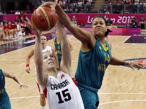 Canada's Michelle Plouffe (15) pulls in a rebound in front of Australia's Liz Cambage (14) during their women's preliminary round basketball game at the 2012 Summer Olympics on Sunday, Aug. 5, 2012, in London.