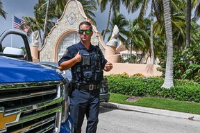 Local law enforcement officers are seen outside the home of former U.S. President Donald Trump at Mar-A-Lago in Palm Beach, Florida August 9, 2022.