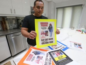 Michael Madeira holds up posters of his dad, Antonio, who walked away from his home near Oakwood Ave. and Vaughan Rd. on July 12.