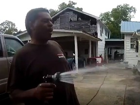 Police bodycam footage shows Pastor Michawl Jennings watering his neighbour's flowers.