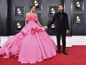 Chrissy Teigen, left, and John Legend arrive at the 64th Annual Grammy Awards at the MGM Grand Garden Arena in Las Vegas, April 3, 2022. Teigen and Legend are expecting another child nearly two years after the couple suffered a pregnancy loss.