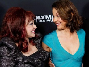 Cast member Ashley Judd (R) and her mother Naomi Judd arrive at the premiere of the movie "Olympus Has Fallen" at the ArcLight Cinema in Hollywood, California March 18, 2013.